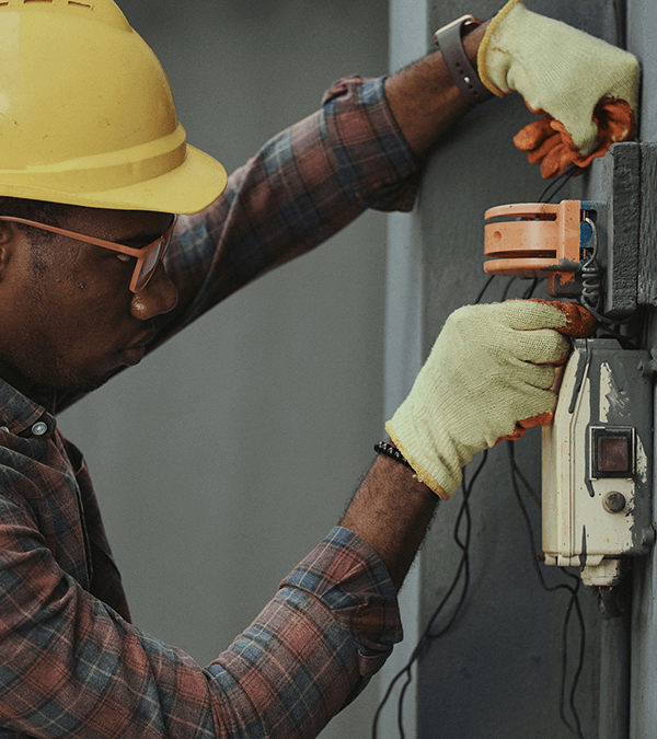 A tradesman rewiring electrics