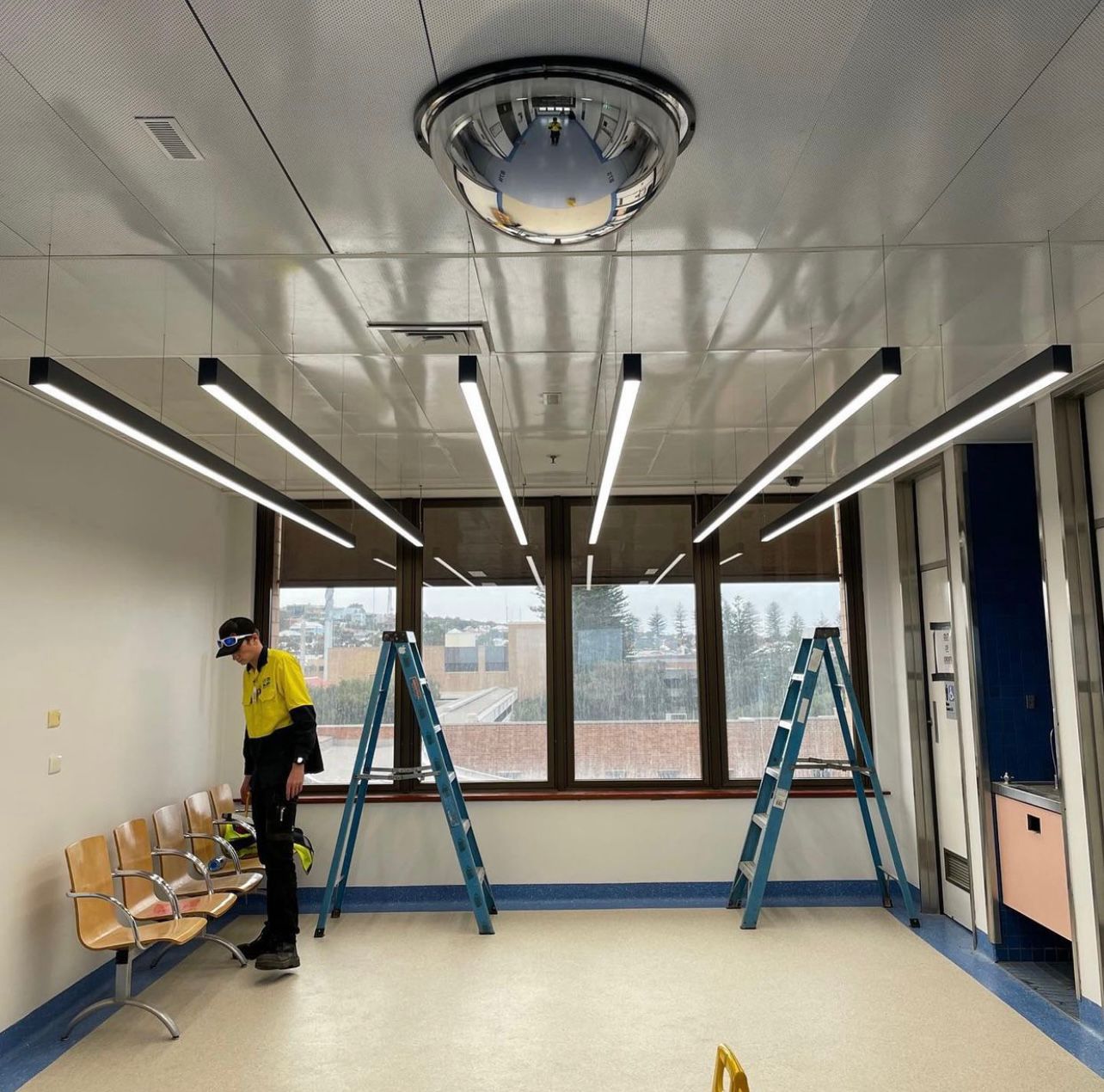 A commercial space with modern lighting and an electrician