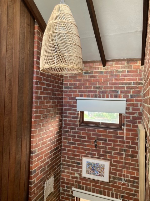 The interior corner of a room with brick and wood surfaces