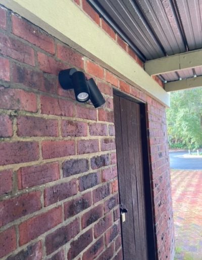 A pair of modern lights on a brick wall
