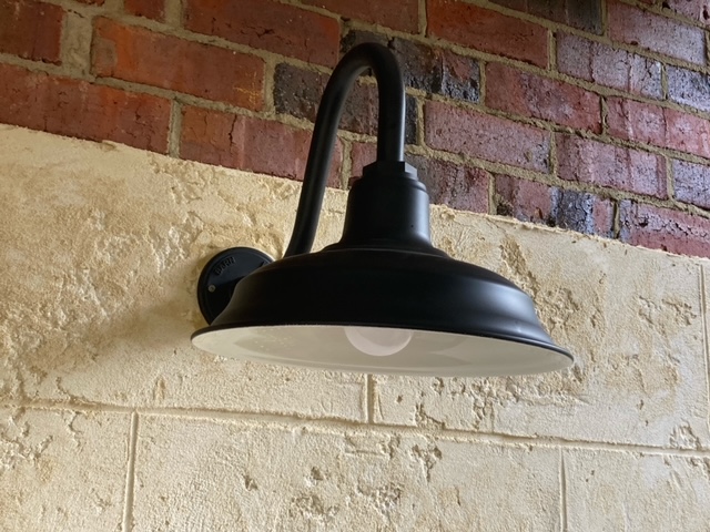An old-fashioned light on a brick wall